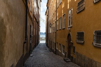 View of narrow cobblestoned street in Gamla Stan, the medieval Old Town of Stockholm