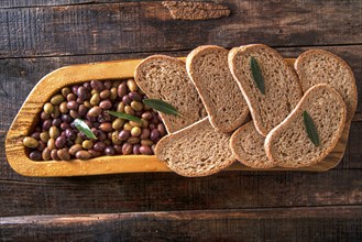 Aperitif made of bread with mixed olives in brine of Tuscany Italy