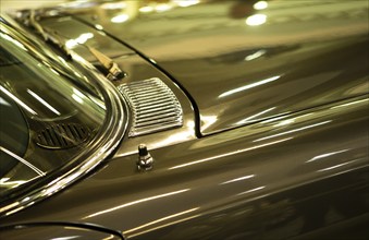 The photo shows a detailed view of a gleaming classic car