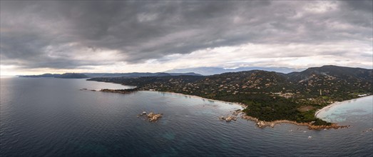 Panorama drone view of Palombaggia Beach and hilly coastline in southeastern Corsica