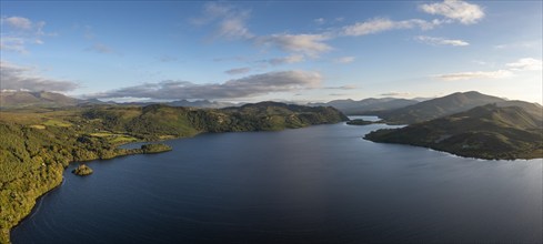 A panorama view of Lough Caragh lake in the Glencar Valley of Kerry County in warm eveing light