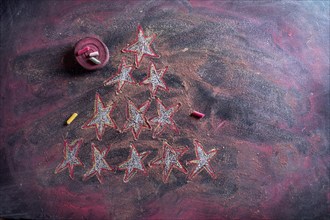 Small stylized christmas tree on blackboard with chalk