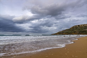 Landscape view of the red sand beach in idyllic Ramla Bay on Gozo Island in Malta