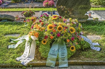 Flowers on a fresh grave in the cemetery