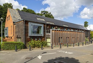 Roof of building covered with photovoltaic solar panels, Framfield health centre surgery,