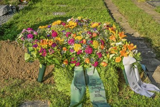 Flowers on a fresh grave in the cemetery