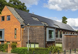 Roof of building covered with photovoltaic solar panels, Framfield health centre surgery,