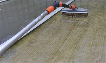 Clean patio roof with telescopic pole and brush