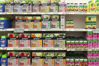 Shelves with boxes of Levington and other fertiliser products, Notcutts garden centre, Woodbridge,