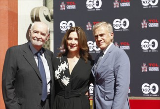 Christoph Waltz supports producers Michael G. Wilson and Barbara Broccoli at their handprints