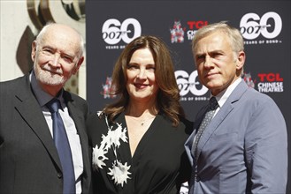 Christoph Waltz supports producers Michael G. Wilson and Barbara Broccoli at their handprints