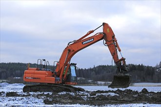 SALO, FINLAND, NOVEMBER 27, 2016: Doosan DX255LC Medium Crawler Excavator at work in the road