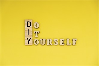 DIY Do It Yourself inscription on yellow background. Handmade home repair decorating handicraft.