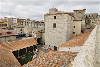 Avila, Spain, November 11, 2014: The Medieval Walls of Avila and the cathedral. Cloudy day. The old