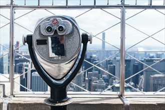 Old Binoculars Against Cityscape of New York. Travel and wanderlust, search or curiosity concepts