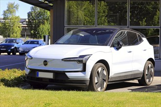 White Volvo EX30, a battery electric subcompact crossover SUV manufactured by Volvo Cars, parked