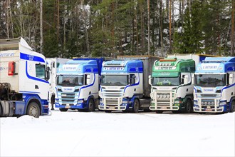 Beautifully customized Scania trucks L. Retva Oy parked at depot on a Sunday morning in winter.