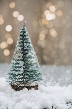 Christmas tree on bokeh light background. Artwork minimal pastel color design for new year. Winter