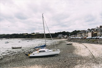 Cancale, France, July 27, 2018: The harbour of Cancale at low tide a cloudy day of summer, French