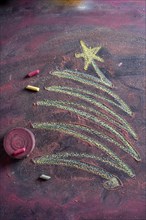 Small stylized christmas tree on blackboard with chalk