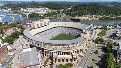 An aerial view of Neyland Stadium reveals a massive, iconic structure nestled by the Tennessee