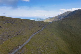 Landscape view with the steep mountain road leading to the top of Connor Pass on the Dingle