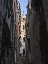 Narrow alley in the old town and church tower, Old Town of Korcula, Dalmatia, Croatia, Europe