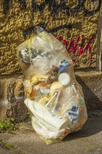 Yellow bag for plastic waste standing on the Bürgergsteig, waste separation, Germany, Europe