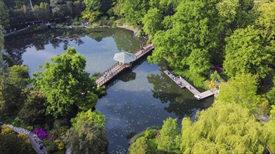 Aerial view on Japanese garden in Wroclaw. Many people in park, rhododendron blossoms, In left lowe