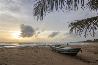 Landscape by the sea and sandy beach. A boat lies in the sand and adds a special touch to the