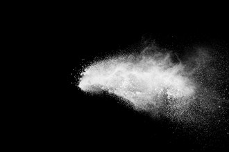 Bizarre forms of white powder explosion cloud against black background.White dust particles splash