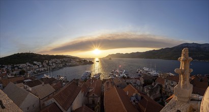 Evening mood at sunset by the sea, view from the bell tower, ships in the harbour of Korcula,