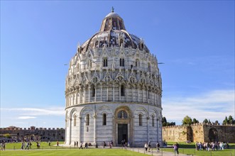 Tourists visit the Baptistery (Battistero) on the Square of Miracles (Campo dei Miracoli) in Pisa,