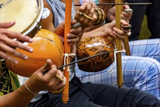 Several afro Brazilian percussion musical instruments during a capoeira performance in the streets