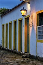 Dusk in the historic city of Paraty with colonial houses and facades illuminated by lanterns