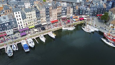 Fantastic drone point of view on Normandian ancient Honfleut town with harbor of sailboats and