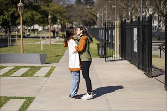 Lesbian couple kissing in a park