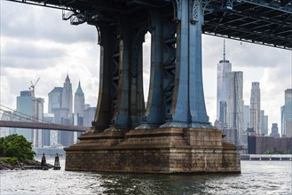 Detail of Pillar of Manhattan Bridge against cityscape of New York City. Steel Abutment With Bolt