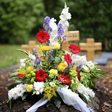 Colourful flowers on a grave after a funeral