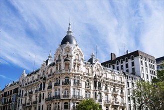 Low angle view of old luxury residential building in Madrid. View against blue sky with space for