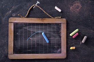 Presentation of small antique school blackboards of the past with chalk and selvedge