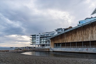 Oslo, Norway, August 11, 2019: Scenic view of sunset on Tjuvholmen quarter a new modern urban