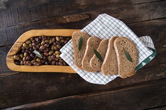 Aperitif made of bread with mixed olives in brine of Tuscany Italy