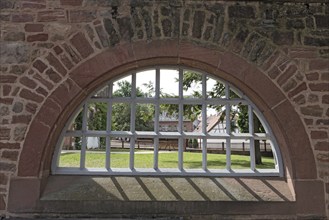 Monastery wall with iron lattice window, Seligenstadt, Hesse, Germany, Europe