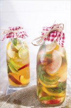 Bottle of infused fruit tea with peach and lemon