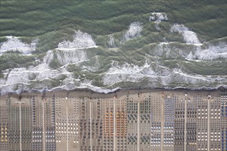 Aerial view of Versilia beach with rough sea photographed from above