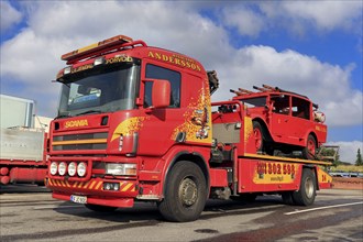 Scania flatbed tow truck of Hinaus Andersson Oy carrying a vintage fire truck. Salo, Finland.