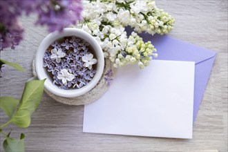 Empty envelope copy space paper note with Tasty black tea in white cup on windowsill with aromatic