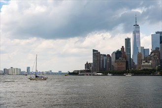 Skyline of Downtown of Manhattan from Goversnors Island a cloudy day of summer. Sailing Ship