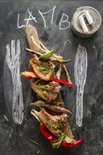 Lamb chops cooked on the grill with leek and red pepper